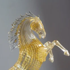 Piccolo cavallo da riproduzione in vetro dorato