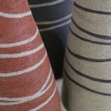 Vaso in gres grigio sabbia testurizzato a forma di bottiglia tronca con intarsi